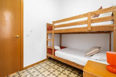 a bedroom with two bunk beds and a desk at Progres in Barcelona