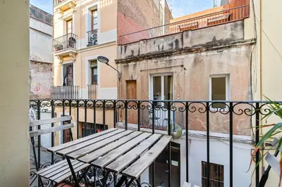 a wooden bench sitting on top of a balcony at Progres in Barcelona