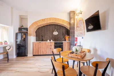 a kitchen with a table and chairs in a room at The Nest Masia Can Tiranasi Relájate y Disfruta Escapada con Encanto Cerca de Barcelona- in Badalona