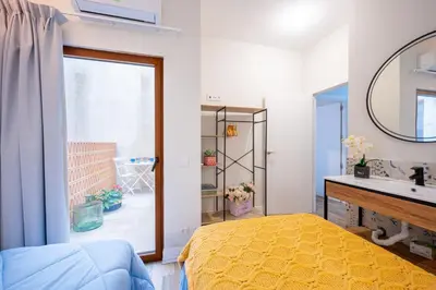 a bedroom with a bed and a sink and a mirror at The Nest Masia Can Tiranasi Relájate y Disfruta Escapada con Encanto Cerca de Barcelona- in Badalona