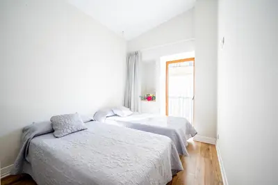 two beds in a white room with a window at The Nest Masia Can Tiranasi Relájate y Disfruta Escapada con Encanto Cerca de Barcelona- in Badalona