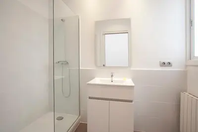 a bedroom with a bed and a painting on the wall at Gran Via modern and bright 3BD with terrace in Barcelona