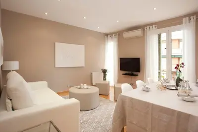 a white bathroom with a sink and a shower at Gran Via modern and bright 3BD with terrace in Barcelona