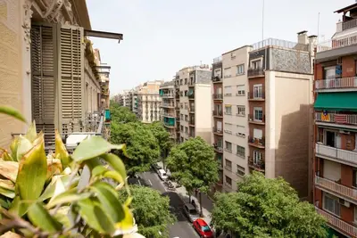 a living room with white furniture and a flat screen tv at Gran Via modern and bright 3BD with terrace in Barcelona
