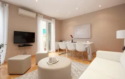 a white bathroom with a sink and a toilet at Gran Via modern and bright 3BD with terrace in Barcelona