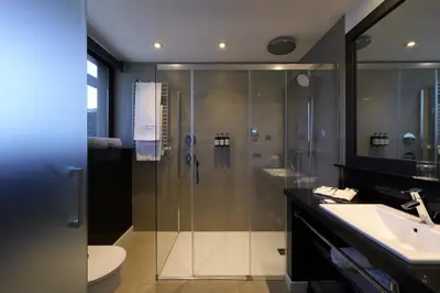 a bathroom with a shower and a toilet and a sink at Catalonia Port in Barcelona