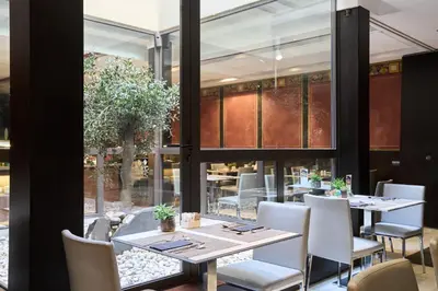 a restaurant with a counter with food on it at Catalonia Port in Barcelona