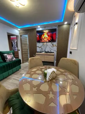 a living room with a table and a couch at Piso luxori in Santa Coloma de Gramanet