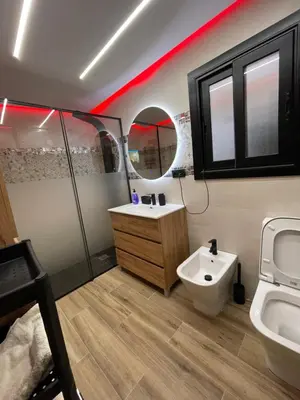 a bathroom with a sink and a toilet and a mirror at Piso luxori in Santa Coloma de Gramanet