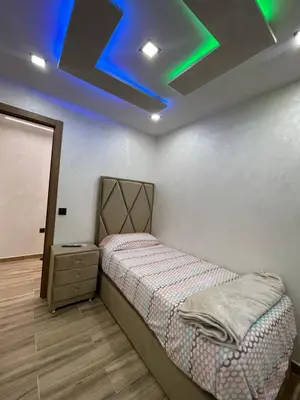 a bedroom with a bed and a blue ceiling at Piso luxori in Santa Coloma de Gramanet