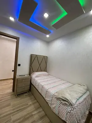 a bedroom with a bed and a blue ceiling at A comfortable apartment in Santa Coloma de Gramanet