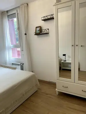 a bedroom with a dresser and a mirror at Beach apartment 2 terraces with parking in Castelldefels