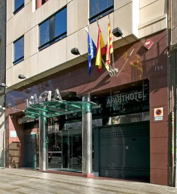 a building with flags in front of a store at Acacia Suite in Barcelona