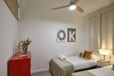 a small room with a bed and a couch at BBarcelona Gracia Apartment in Barcelona