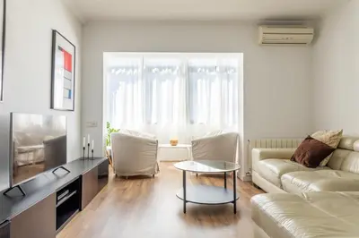 a living room with a couch and a table at Sagrada Familia views, big and bright apartment in Barcelona
