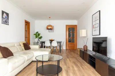 a living room with a white couch and a table at Sagrada Familia views, big and bright apartment in Barcelona