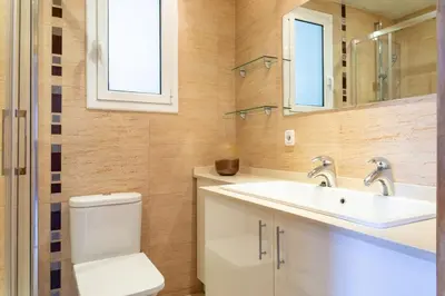 a bathroom with a toilet and a sink and a mirror at Sagrada Familia views, big and bright apartment in Barcelona