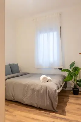 a bedroom with a bed with two towels on it at Sagrada Familia views, big and bright apartment in Barcelona