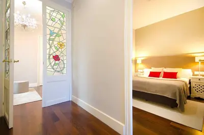a bedroom with a bed and a stained glass window at Three bedroom apartment in Gran de Gracia - You Stylish Apartments in Barcelona