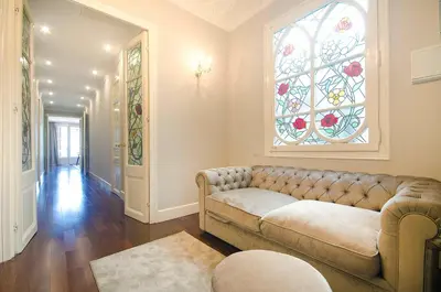 a living room with a couch and a stained glass window at Three bedroom apartment in Gran de Gracia - You Stylish Apartments in Barcelona