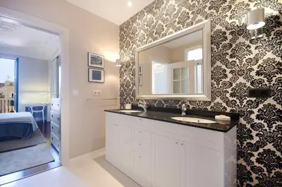 a bathroom with a sink and a mirror on a wall at Three bedroom apartment in Gran de Gracia - You Stylish Apartments in Barcelona
