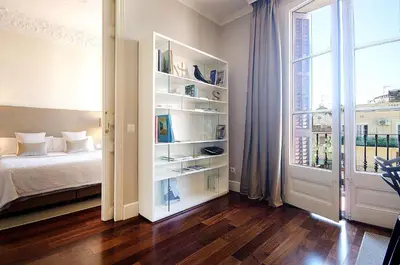 a bedroom with a bed and a large window at Three bedroom apartment in Gran de Gracia - You Stylish Apartments in Barcelona
