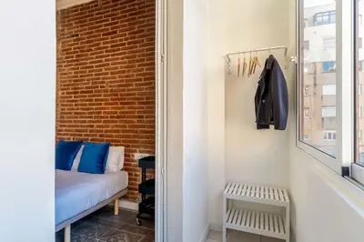 a small bedroom with a bed and a window at 4305 - AB Eixample Sepúlveda 157 in Barcelona