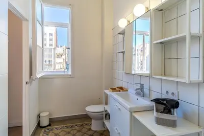 a bathroom with a toilet and a sink and a window at 4305 - AB Eixample Sepúlveda 157 in Barcelona