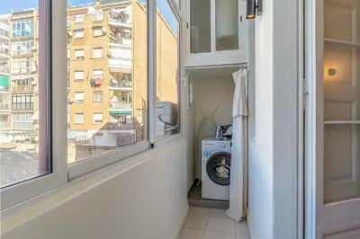 a laundry room with a window and a washing machine at 4305 - AB Eixample Sepúlveda 157 in Barcelona