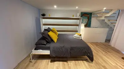 a bed in a room with a staircase at Apartment close Barcelona - Rentals Badalona Beach - Free Parking in Badalona