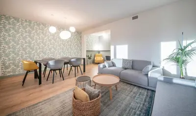 a living room with a couch and a table and chairs at Central One bedroom apartment You Stylish Apartments in Barcelona
