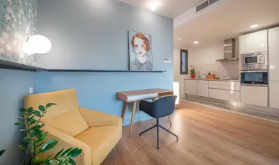 a living room with a couch and a table at Central One bedroom apartment You Stylish Apartments in Barcelona