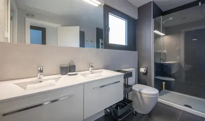 a bathroom with two sinks and a toilet at Central One bedroom apartment You Stylish Apartments in Barcelona