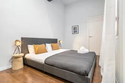 a bedroom with a large bed with orange pillows at Muntaner in Barcelona