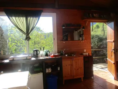 a kitchen with a sink and a window at Climbers Cabin in Marganell