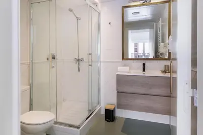 a bathroom with a shower and a toilet and a sink at Rainbow Sitges in Sitges