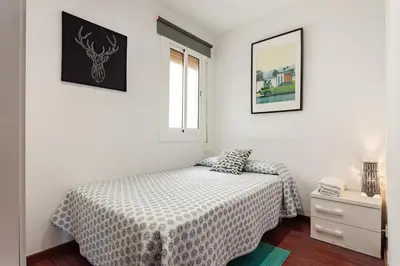 a bedroom with a bed and a door to a hallway at Camp nou Apartamento in Hospitalet de Llobregat