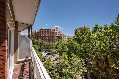 a balcony of a building with trees and buildings at Sweett - Gaudi Avenue in Barcelona
