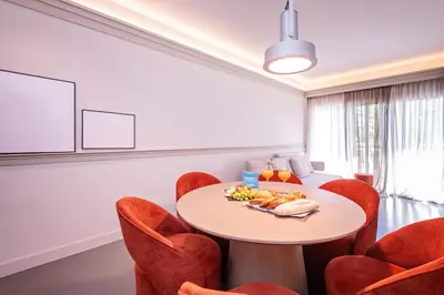 a dining room with a table and red chairs at Sweett - Gaudi Avenue in Barcelona