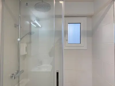 a bathroom with a shower with a glass door at Villa Leonardo in Castelldefels