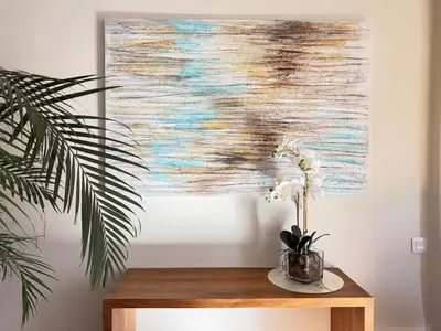 a painting on a wall next to a table with flowers at Villa Leonardo in Castelldefels