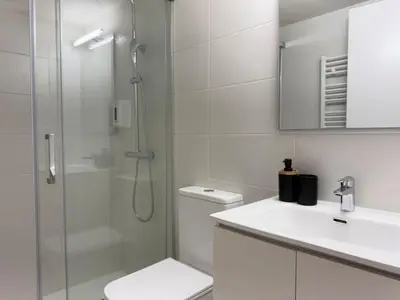 a bathroom with a shower and a toilet and a sink at Villa Leonardo in Castelldefels