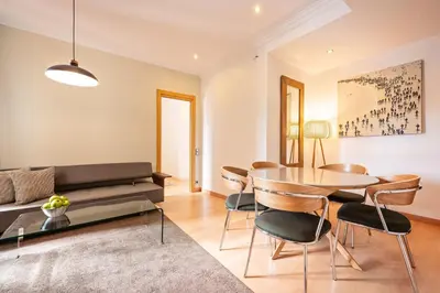 a living room with a couch and a table and chairs at Sweett - Vicky Barcelona in Barcelona