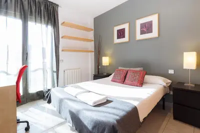 a bedroom with a large bed and a window at Playa Beach Barcelonastuff Apartments in Barcelona