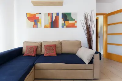 a couch with pillows on it in a room at Playa Beach Barcelonastuff Apartments in Barcelona