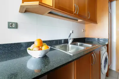 a kitchen with a bowl of fruit on a counter at Playa Beach Barcelonastuff Apartments in Barcelona
