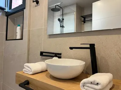 a bathroom with a bowl sink and a mirror at Beautiful renovated studio in Castelldefels