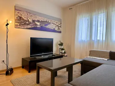 a living room with a tv and a couch at Spacious home in Bonanova in Barcelona