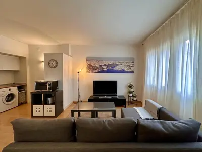 a living room with a couch and a table at Spacious home in Bonanova in Barcelona