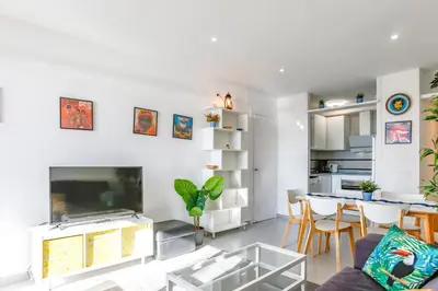 a living room with a fireplace and a dining room at AIGUADOLÇ APARTMENT in Sitges